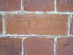 A brick in a Paxton House exterior wall, with the neatly inscribed initials AJP