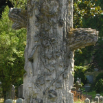 TREE STUMP: A life cut short in its prime. Some iconographers believe that the branches represent other deceased family members. Inclusion of ivy, lilies, and other plants represents faith in resurrection and eternal life.
